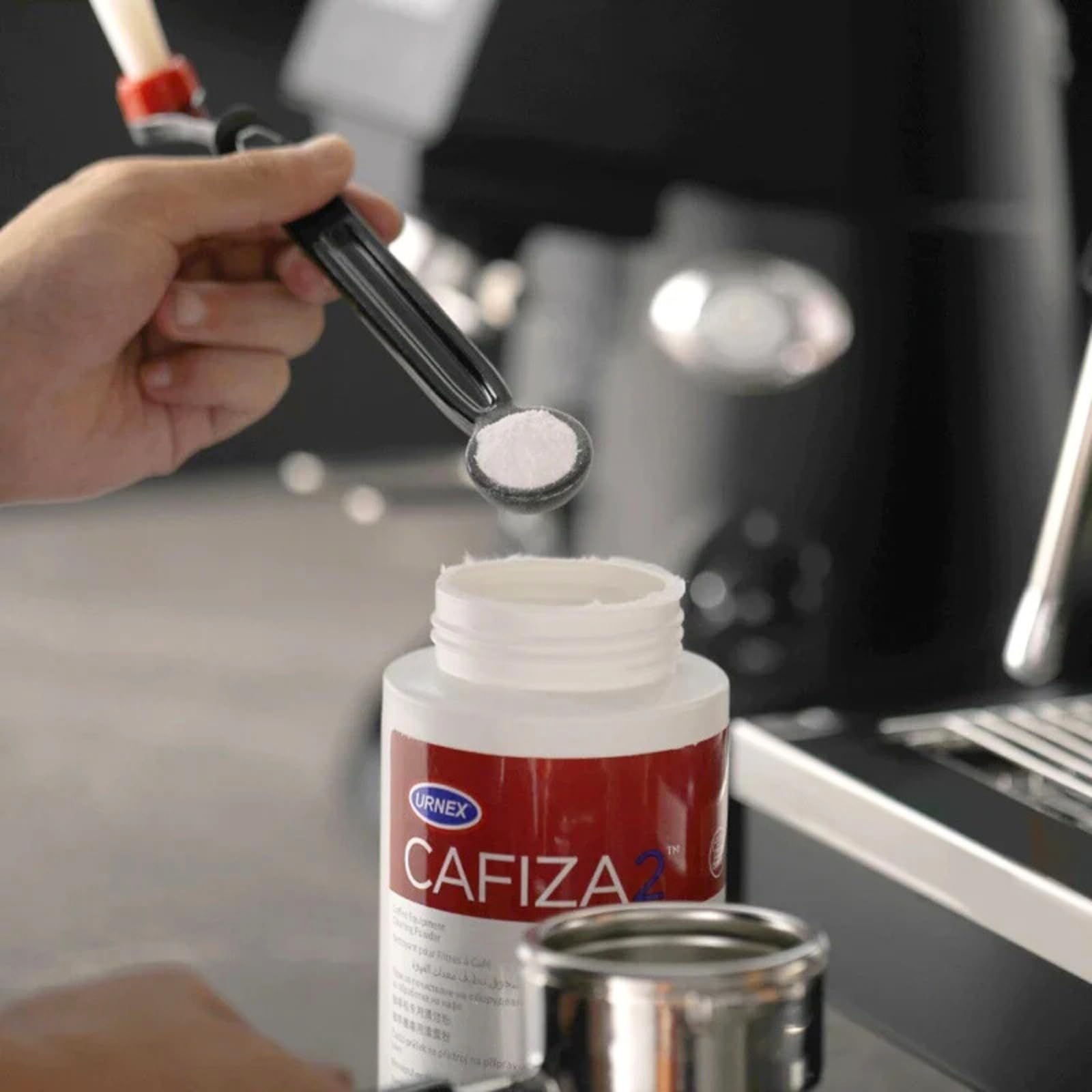 Urnex Cafiza professional espresso machine cleaner in use