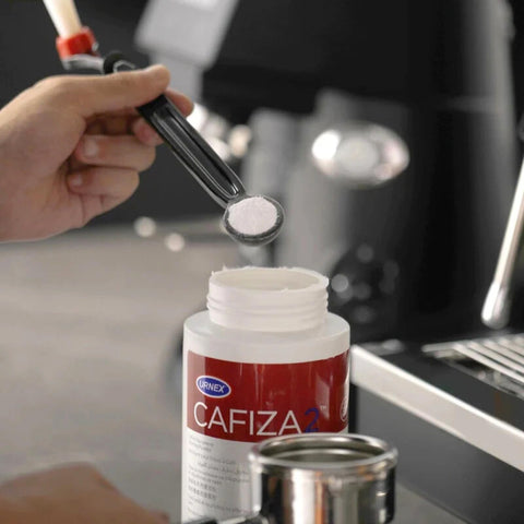 Urnex Cafiza professional espresso machine cleaner in use