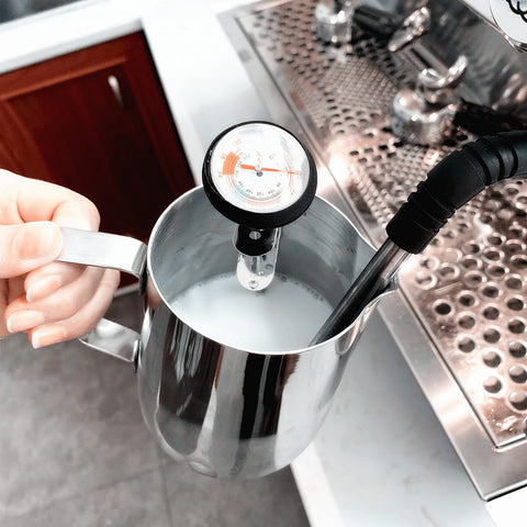 UZER stainless steel milk pitcher with precision spout for controlled pour and microfoam.