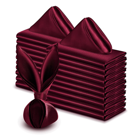 VACVELT Burgundy satin napkins folded elegantly for wedding reception tables.