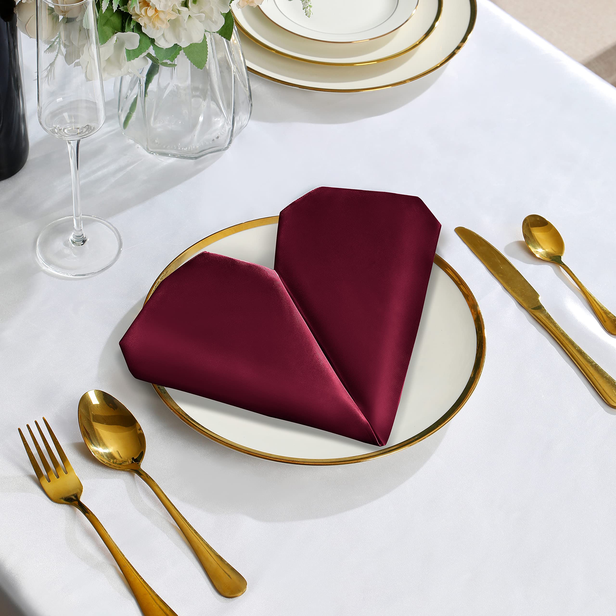 VACVELT Burgundy satin napkins at a wedding decor setup for ambiance.