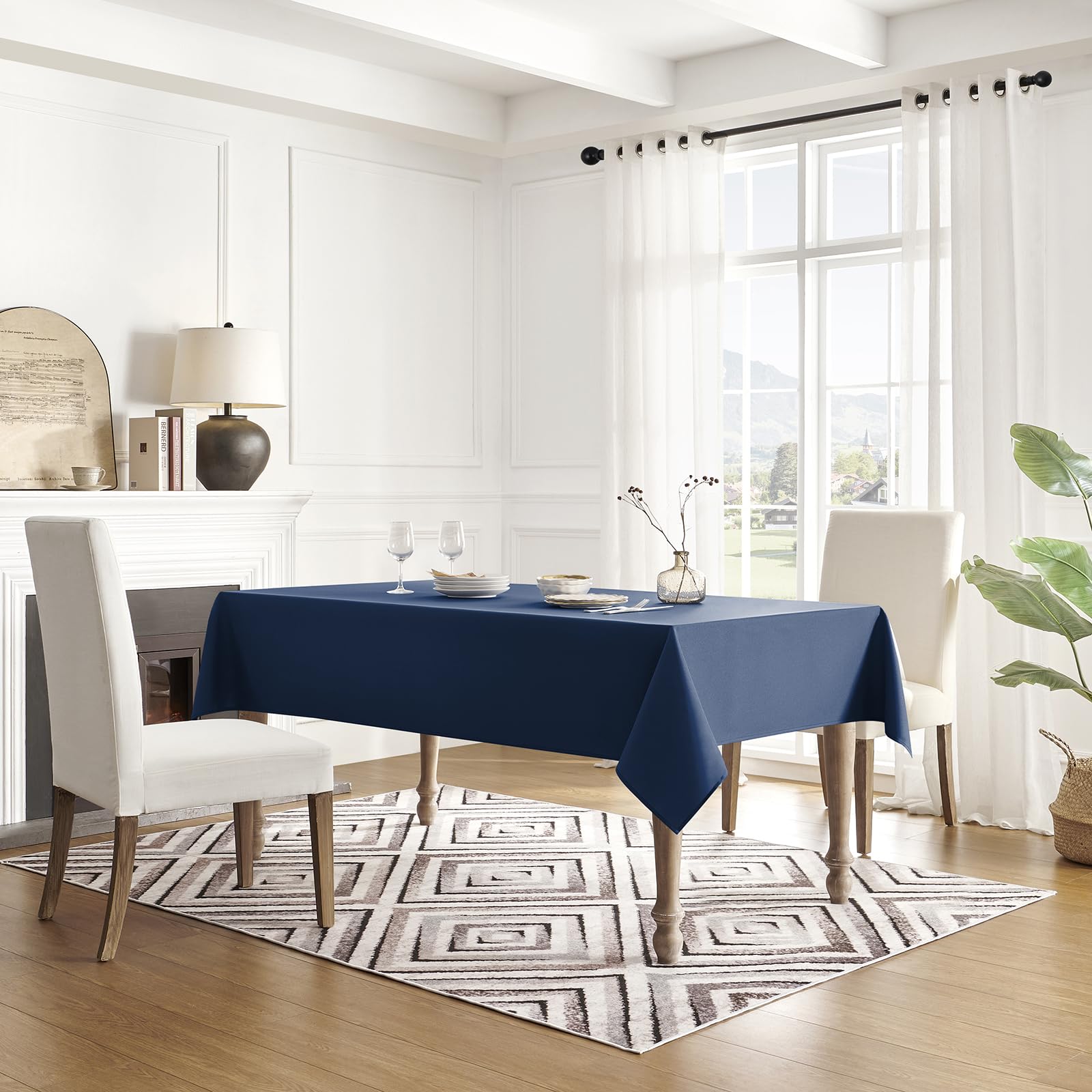 Veblandy spill-proof tablecloth in navy blue over a coffee table.