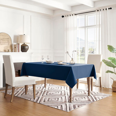 Veblandy spill-proof tablecloth in navy blue over a coffee table.