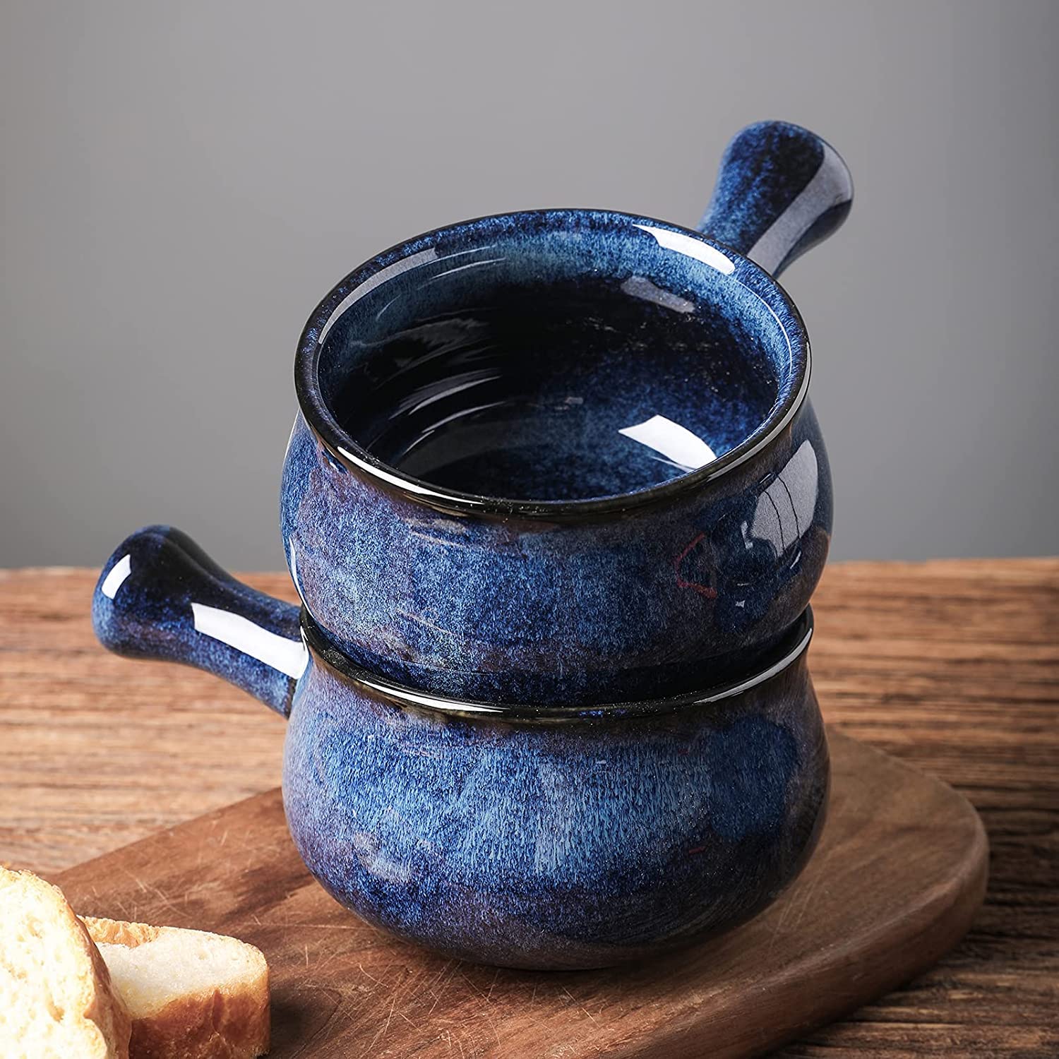Vicrays blue soup bowl in use holding chili, showing secure grip with the handle