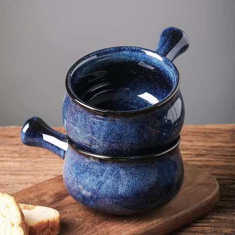 Vicrays blue soup bowl in use holding chili, showing secure grip with the handle