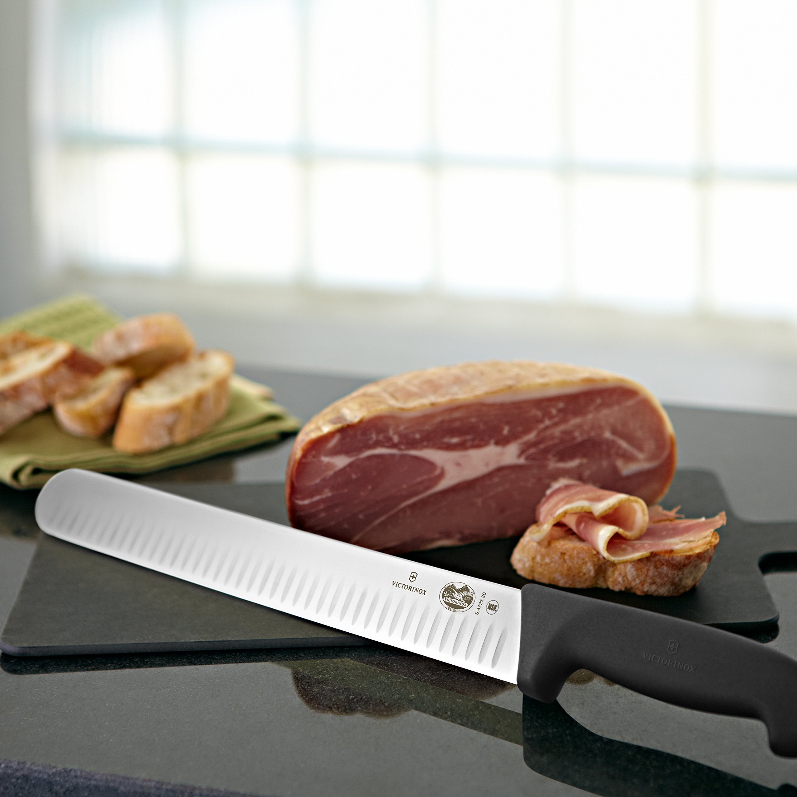 Victorинox Fibrox slicing knife with ergonomic black handle for comfortable prep sessions.