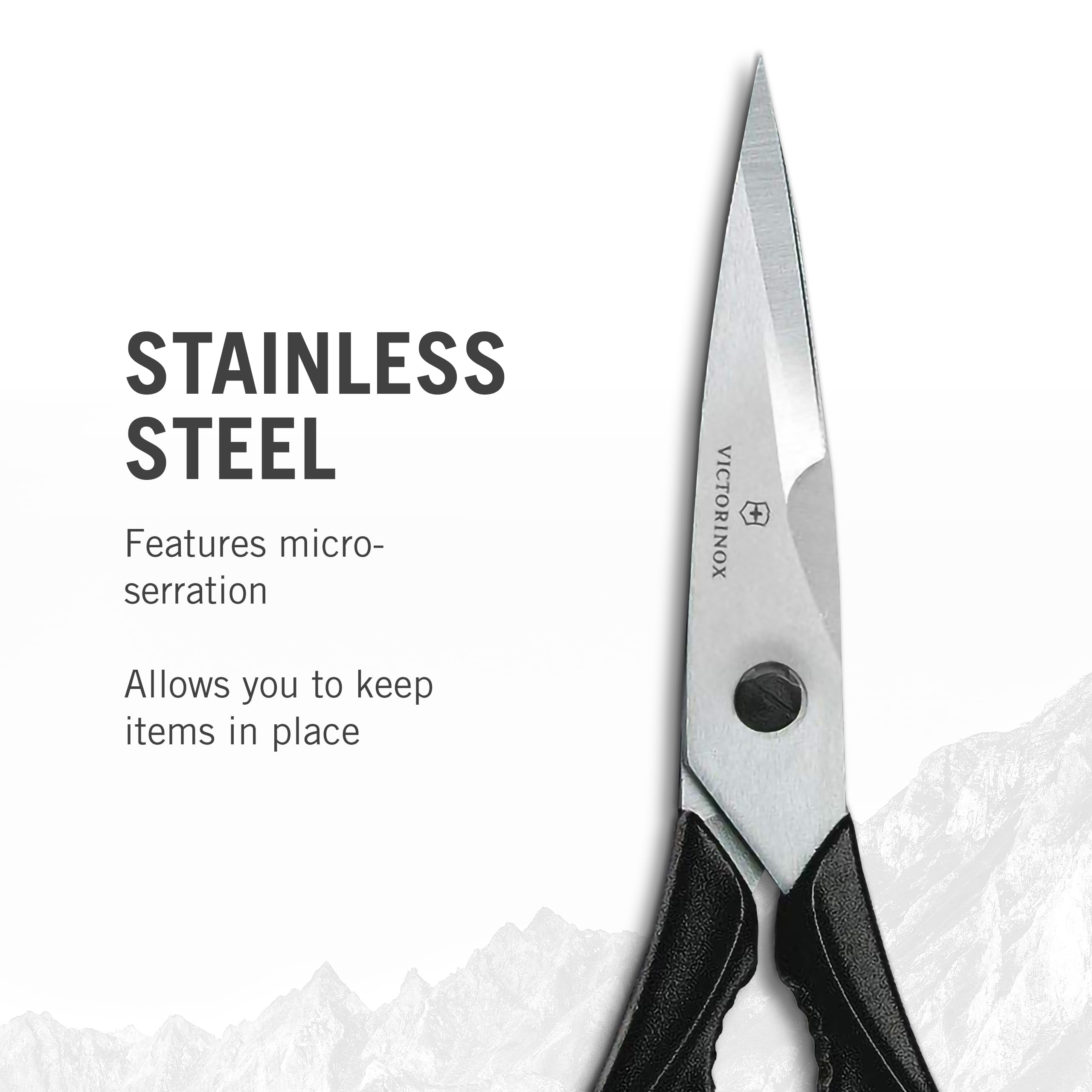 Victorinox Swiss Classic Come Apart Kitchen Shear with micro-serrated blades gripping herbs and vegetables for precise cuts.