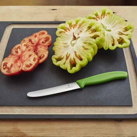 Victorinox Swiss Classic tomato knife green handle full view on a dish for everyday prep