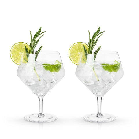 Viski Raye glisten under bar lighting, showcasing garnishes and botanicals.