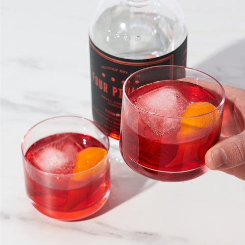 Viski Raye crystal glasses pair well with bourbon or gin on a bar cart.