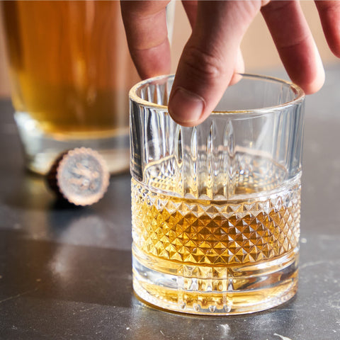 Viski Revolve bourbon glass featuring facets for a radiant look.