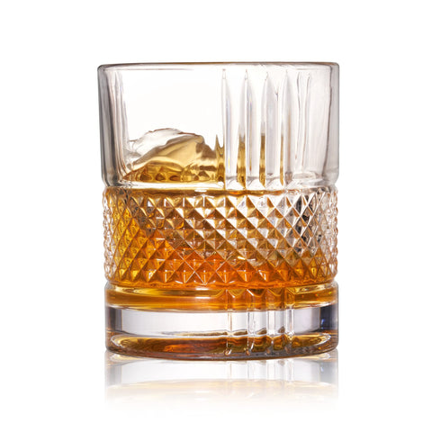 Viski Revolve spinning bourbon glass on a bar counter.