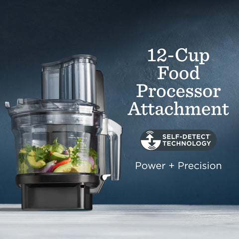Vitamix food processor lid with integrated pushers for controlled processing.