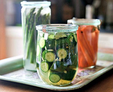 WECK Tulip jar filled with starter beside measuring tools and grains.