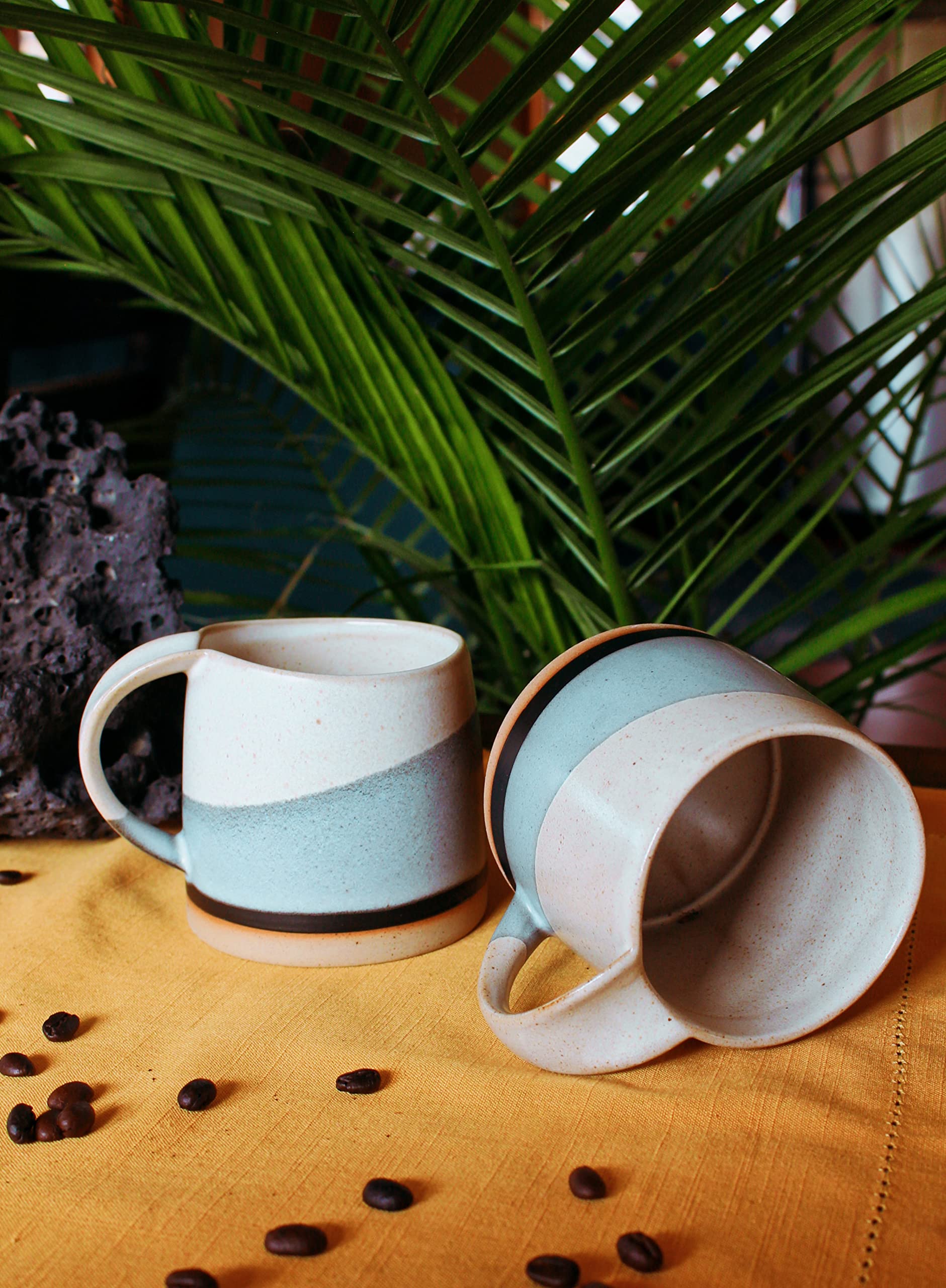 Well Covered & Green Original Day ceramic mug set shown with matching pieces in a display