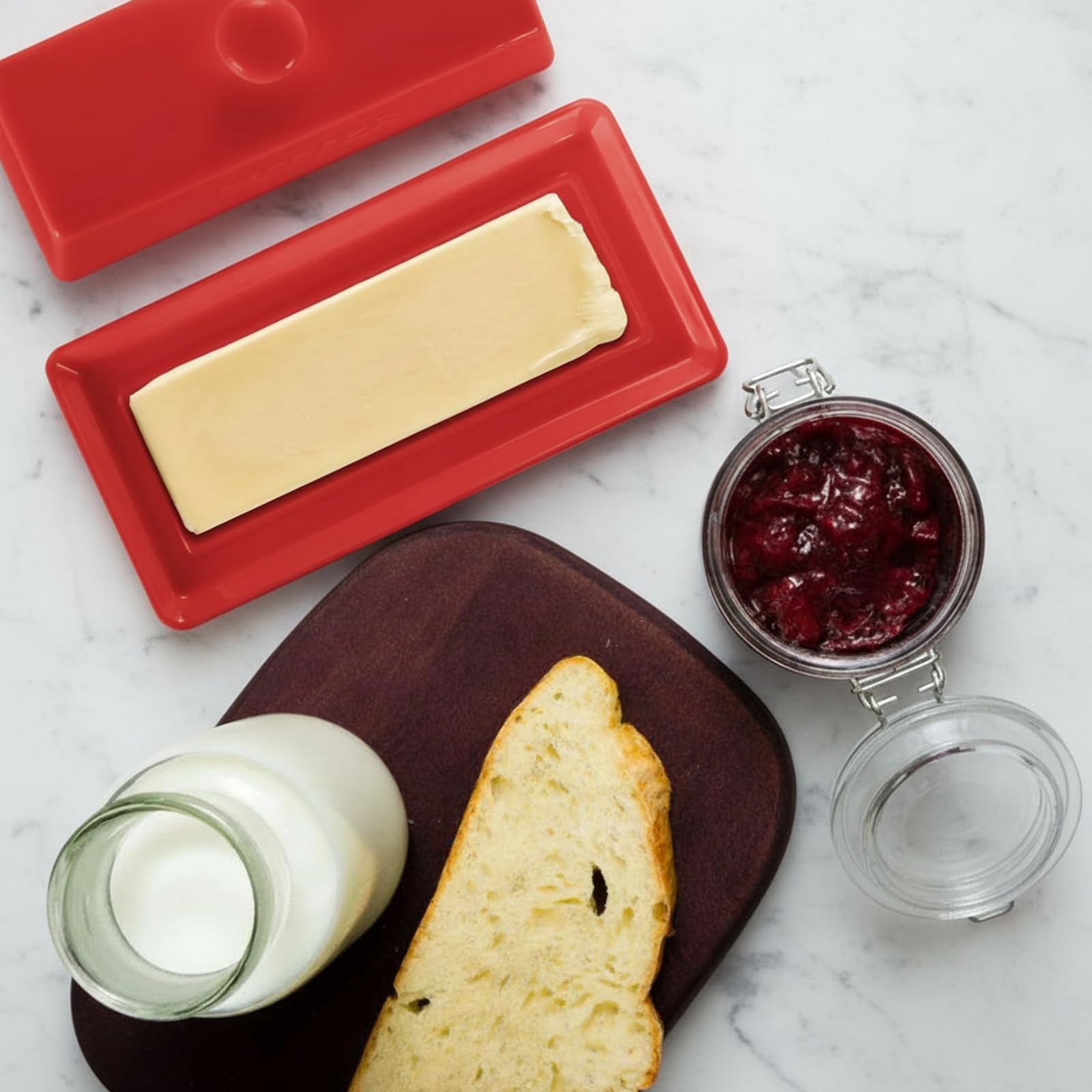WERTIOO red enameled knife complements the butter dish for stylish serving.
