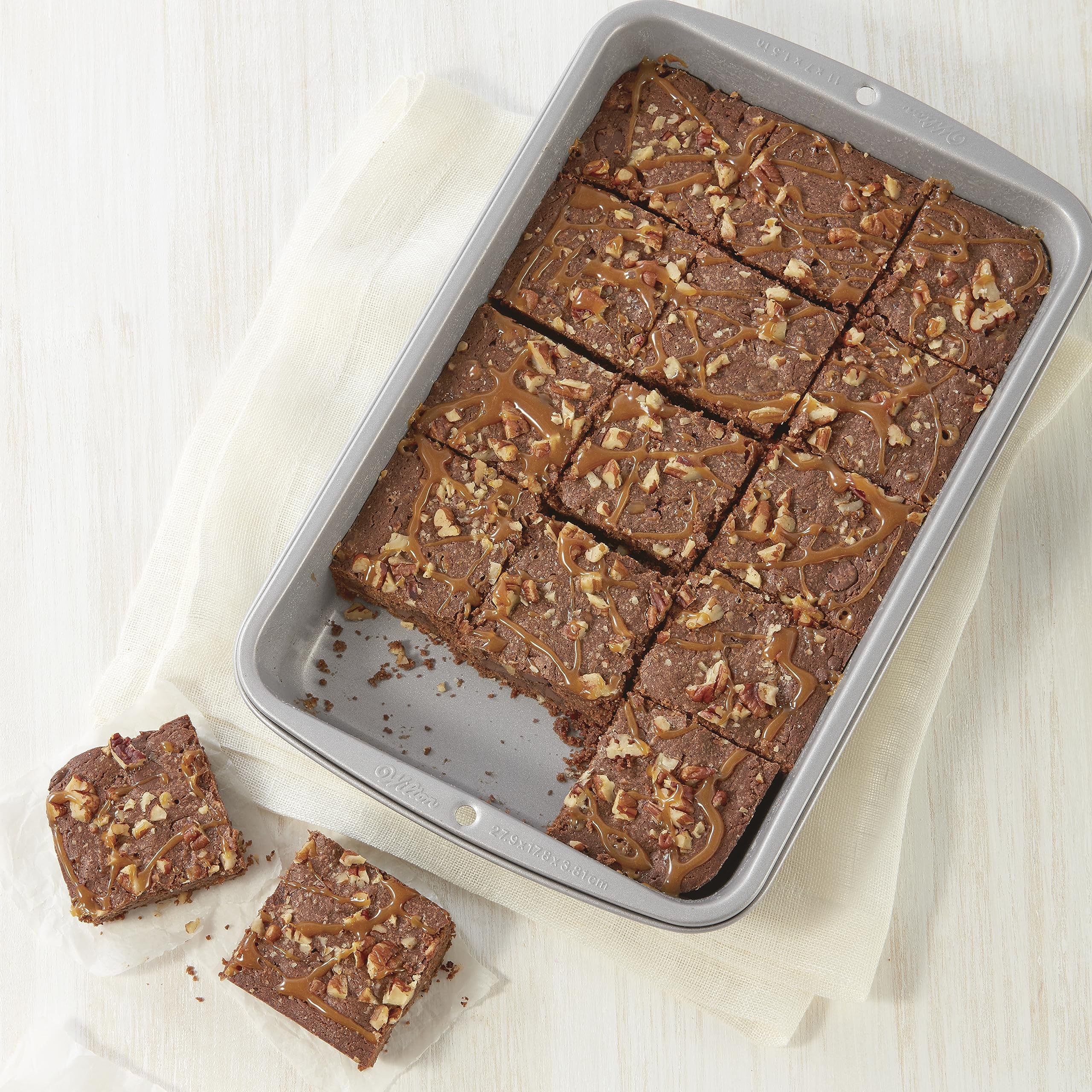 Two pans with sturdy handles enable safe transfers from oven.