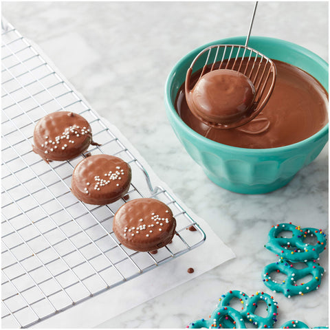 Wilton Candy Melts Dipping Scoop shows full-dip action keeps candy clean.