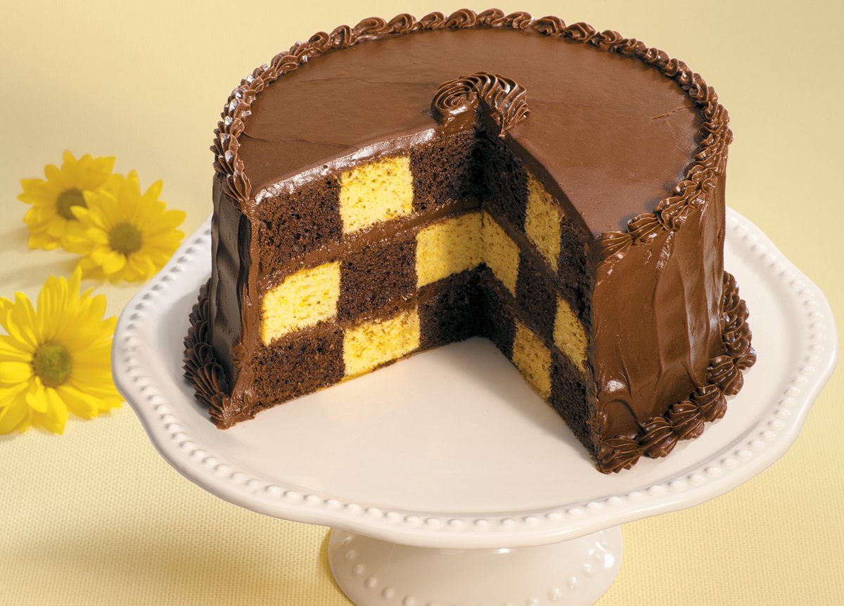 Wilton three-layer setup shows colorful flavors peeking through checkerboard.
