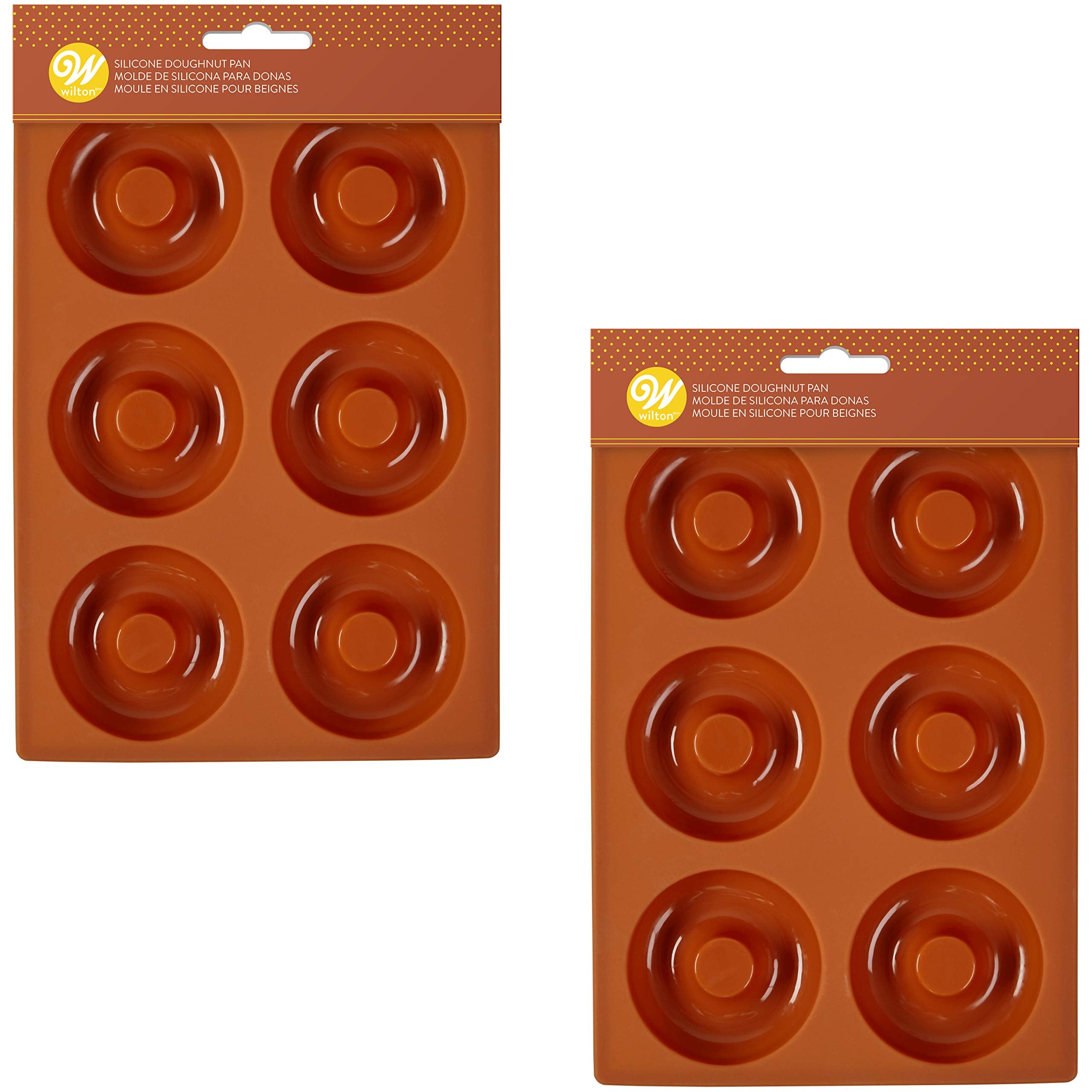 Wilton donut pans shown cooling donuts on a rack for even setting.
