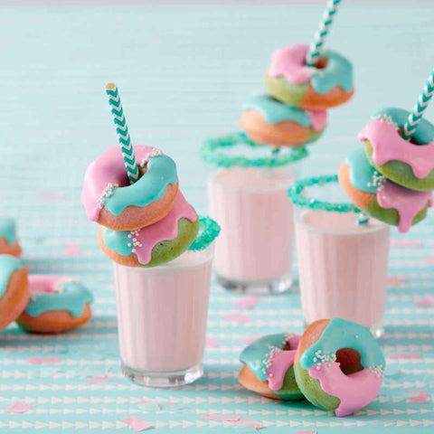 In-use view of the Wilton Mini Donut Pan shows batter filling and shaping donuts.