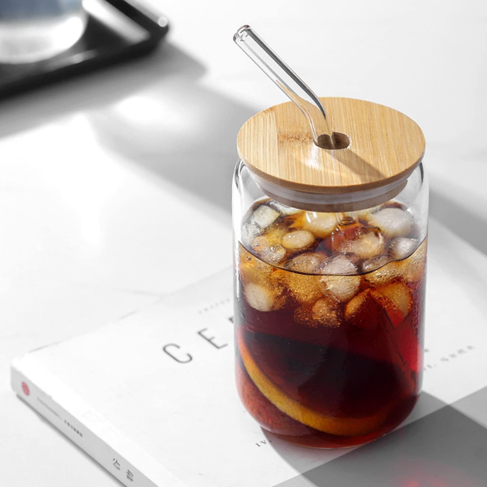 Wisimmall reusable glass straw in use for cold beverages.