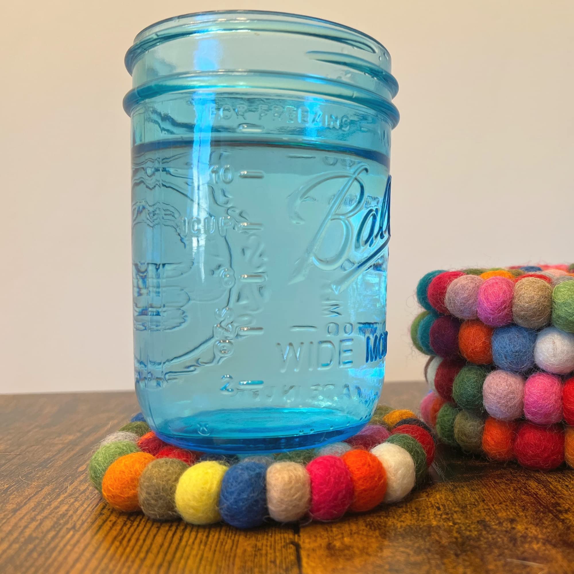 Woolygon coasters feature non-slip backing to keep drinks steady.