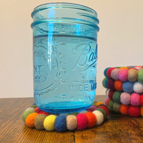 Woolygon coasters feature non-slip backing to keep drinks steady.