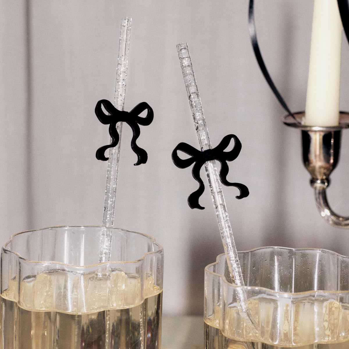 xo Fetti clear glitter straw set with black bow topper for festive celebrations.
