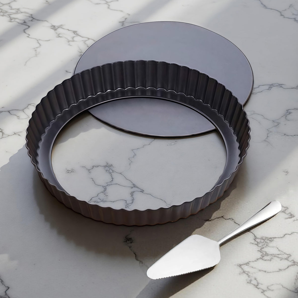 Yamteck 9-inch tart pan with removable bottom for easy demolding and clean edges.