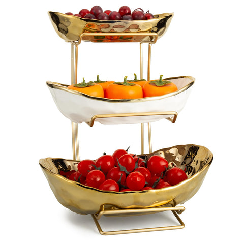 YYW white gold ceramic fruit stand on countertops showcasing fruit, nuts, and desserts.