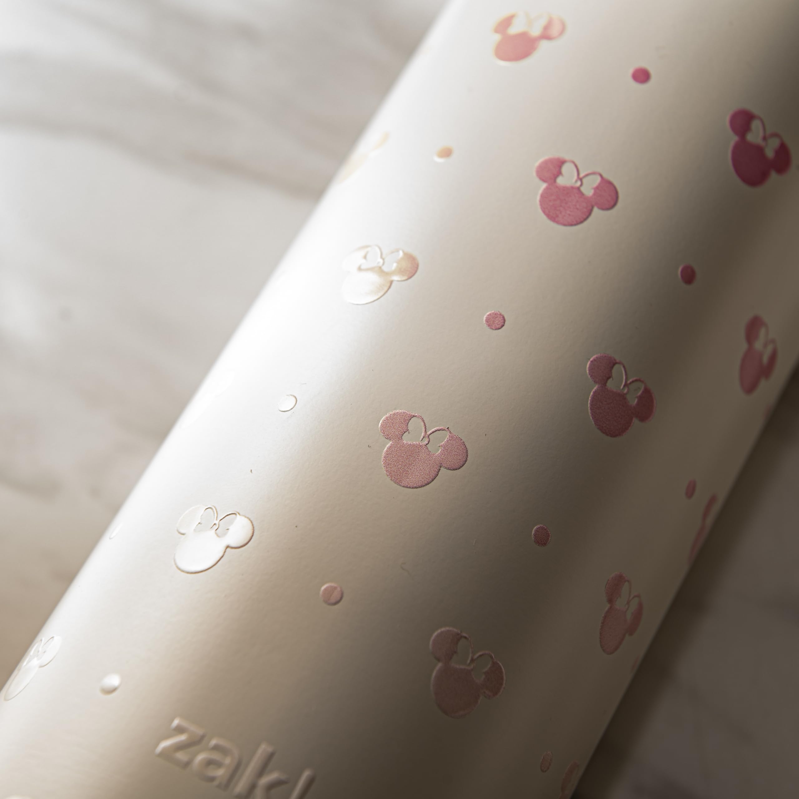 Minnie Mouse Harmony bottle carries with built-in handle for travel convenience.