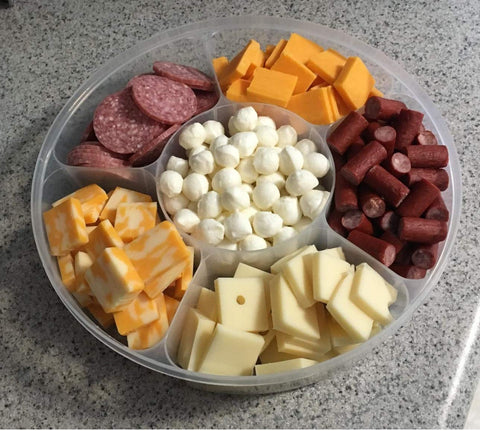 Zilpoo six-compartment round tray showcases colorful nuts, candies, and nibbles neatly.