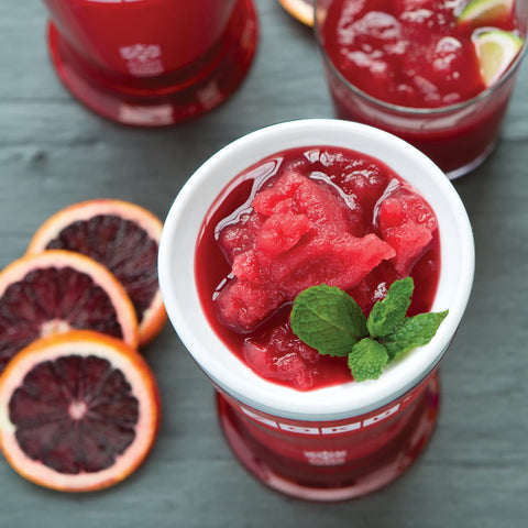 ZOKU slush spoon and outer cup in use, enabling easy scraping.