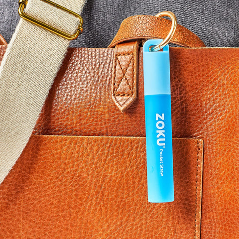 ZOKU travel case attached to a key ring for on-the-go