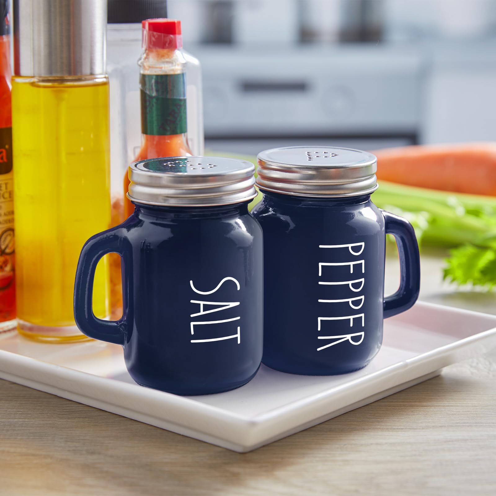 Close-up of glass shakers with stainless steel lids by ZOSUJO.