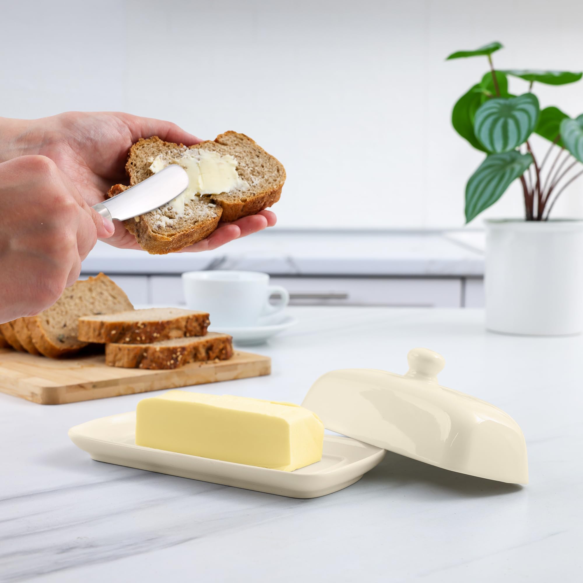 Zulay butter dish on countertop with lid keeps butter ready for toast.